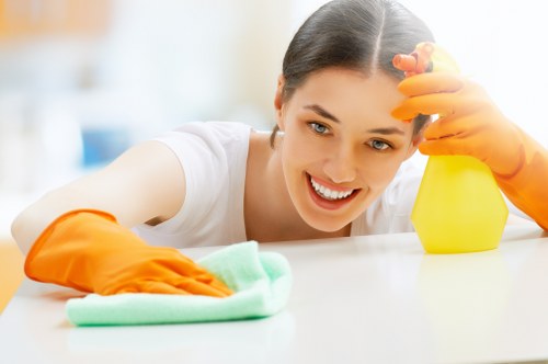 Technician safely preparing oven cleaning equipment in a kitchen