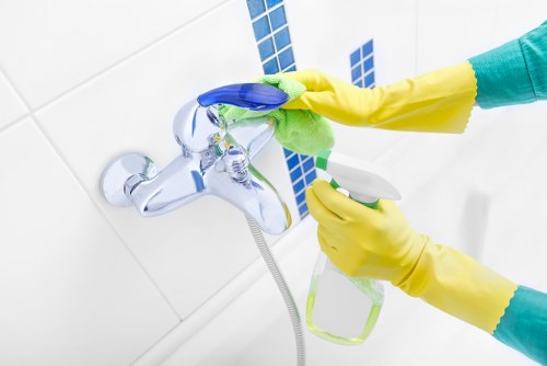 Oven cleaner inspecting appliance and surrounding area for hazards